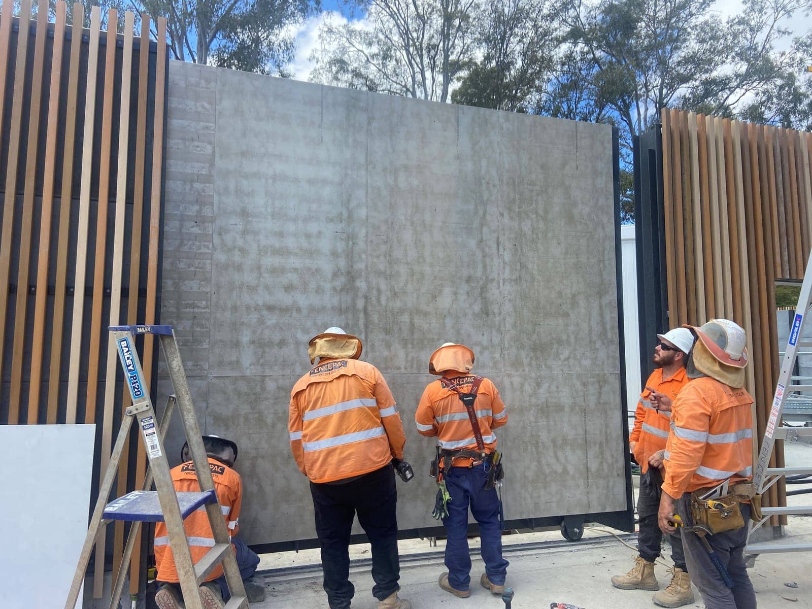 Fencepac crew standing a large wall panel between timber batten sections