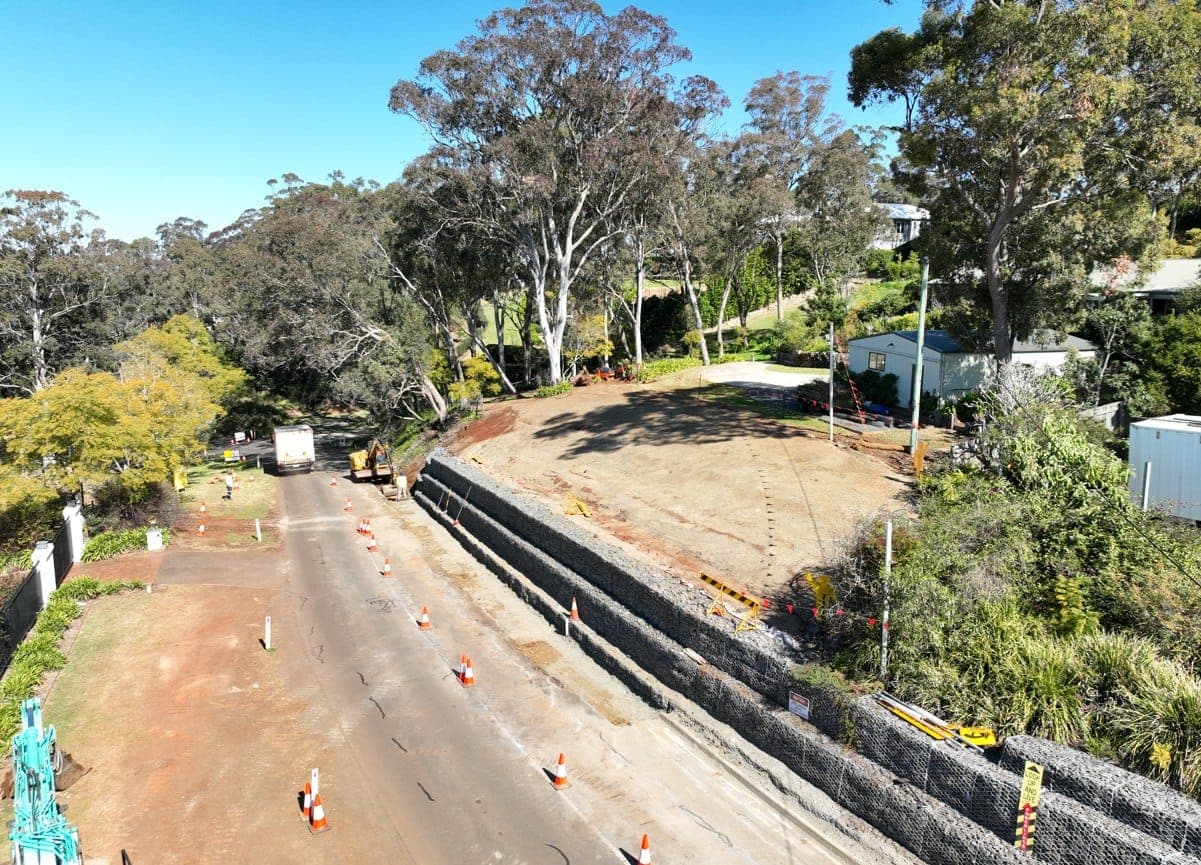 Massive gabion retaining wall aerial view with red earth and bushland