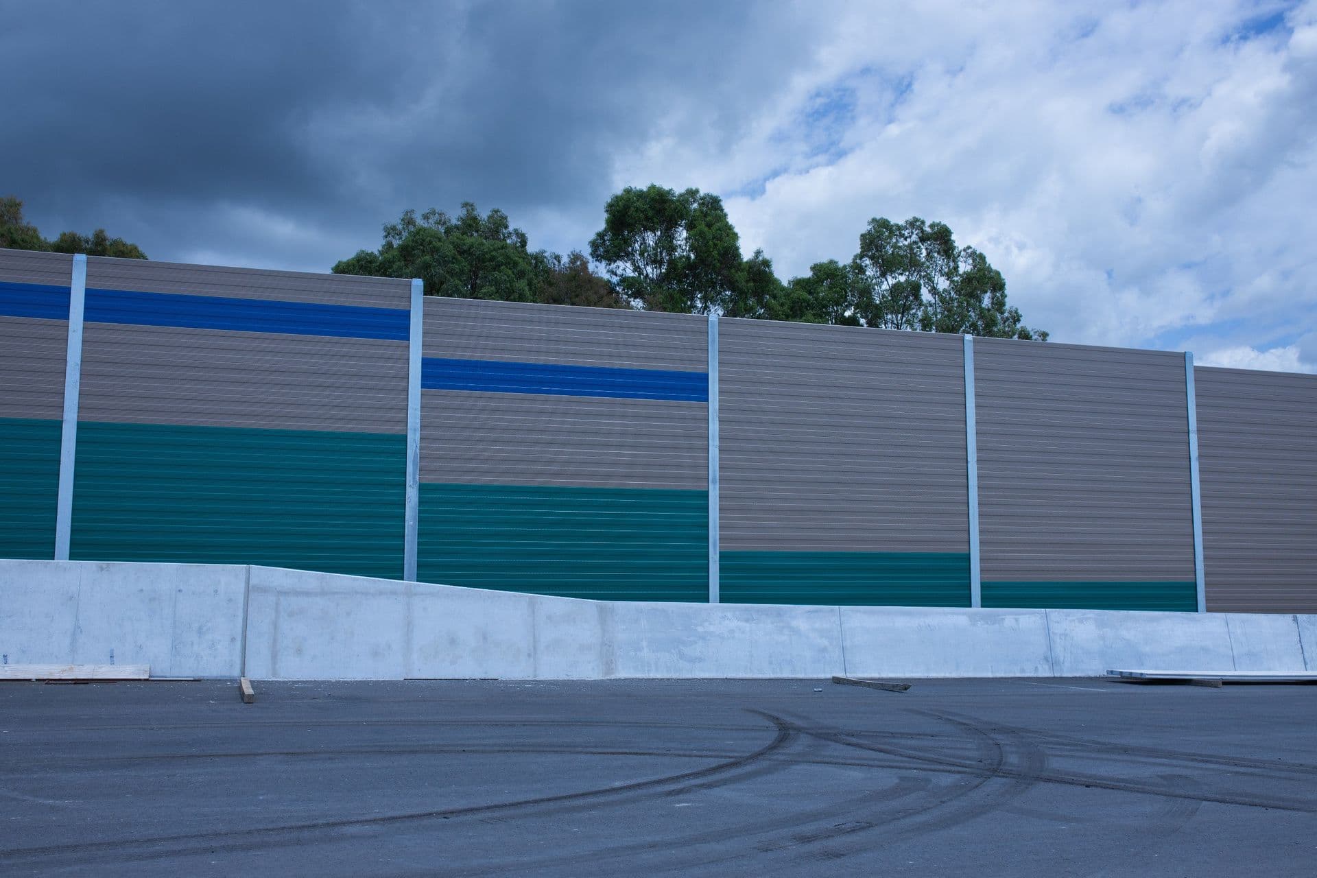 Teal and blue louvre noise barrier panels wide angle