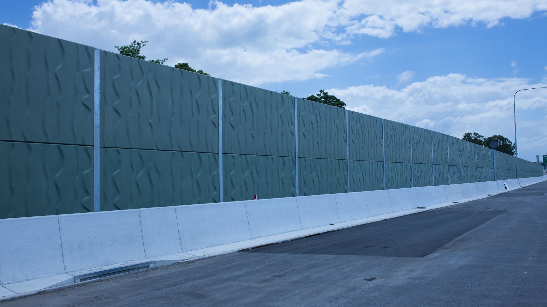 Textured green concrete Noise Wall panels along a Queensland highway corridor