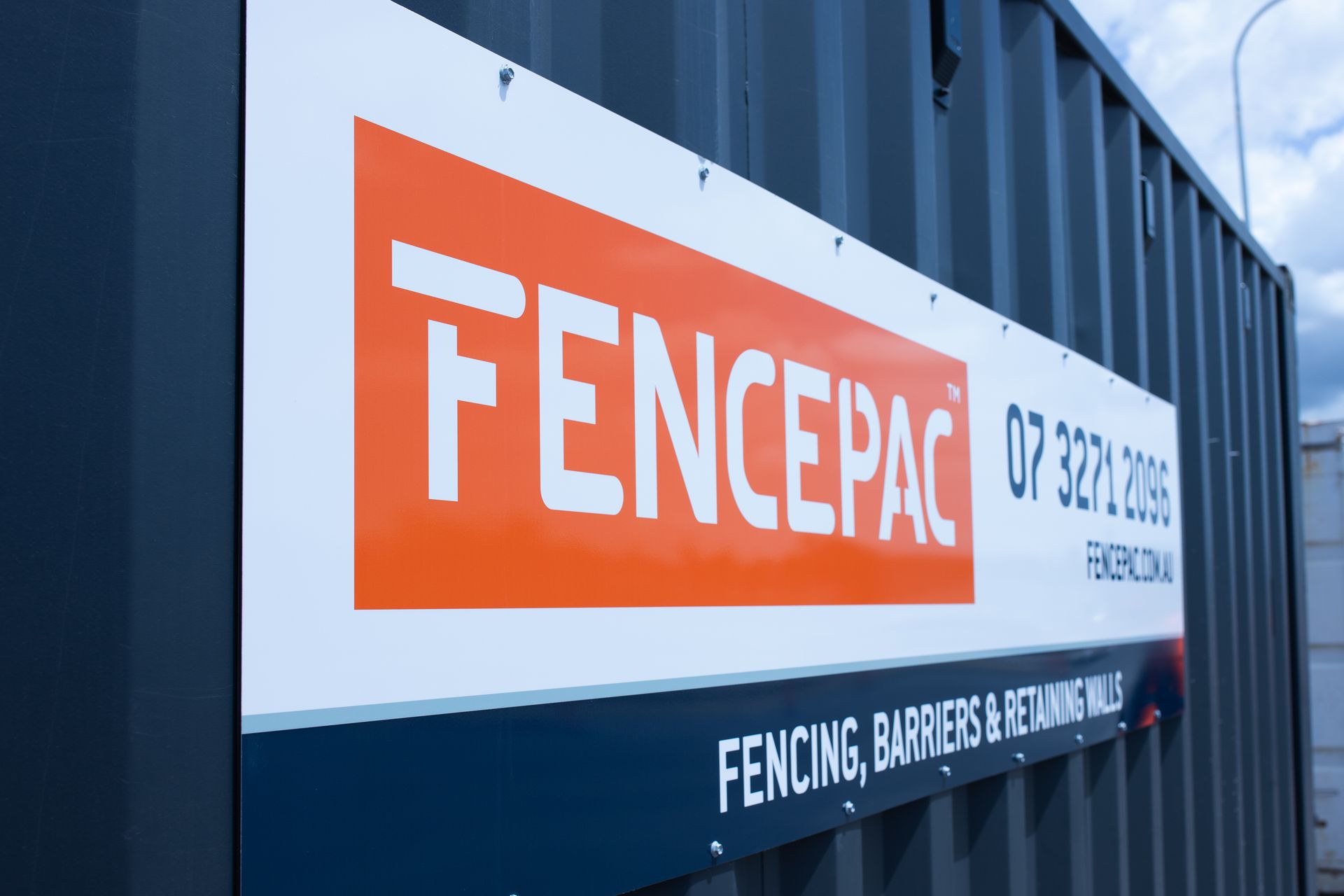 Fencepac branded shipping container on Coomera project site with crew in hi-vis
