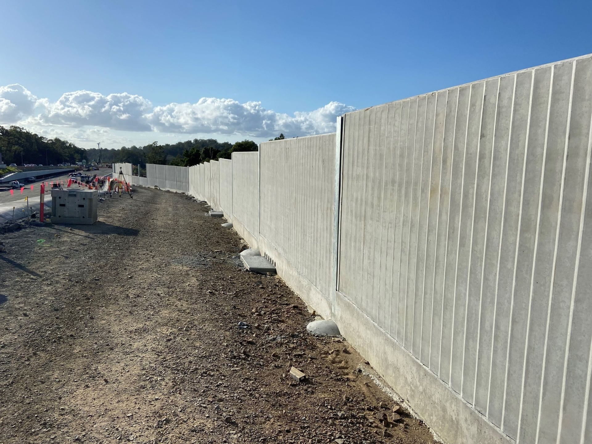 Raw concrete noise barrier panels during construction