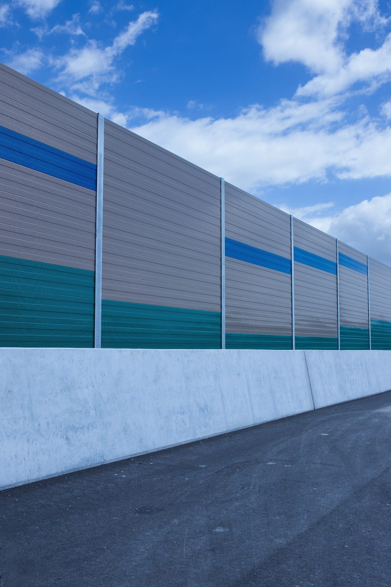 Teal and blue louvre acoustic barrier — portrait angle