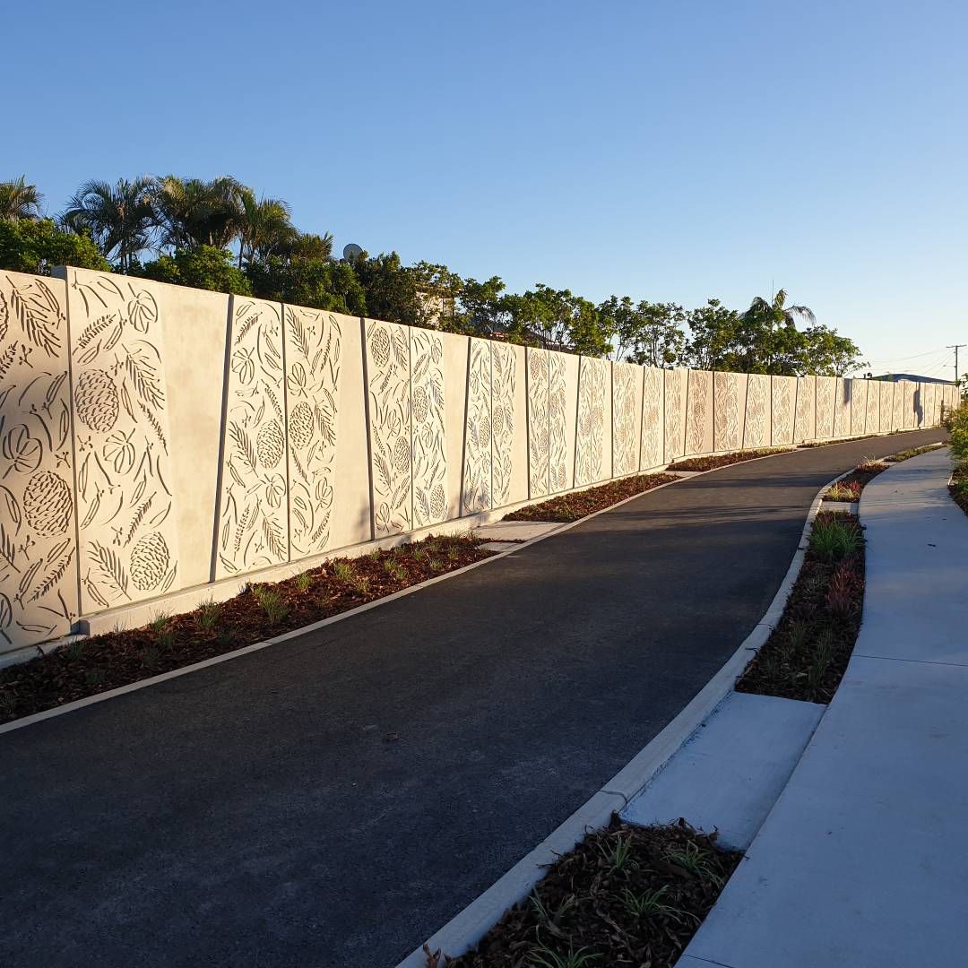 Botanical embossed decorative noise barrier panels along pathway
